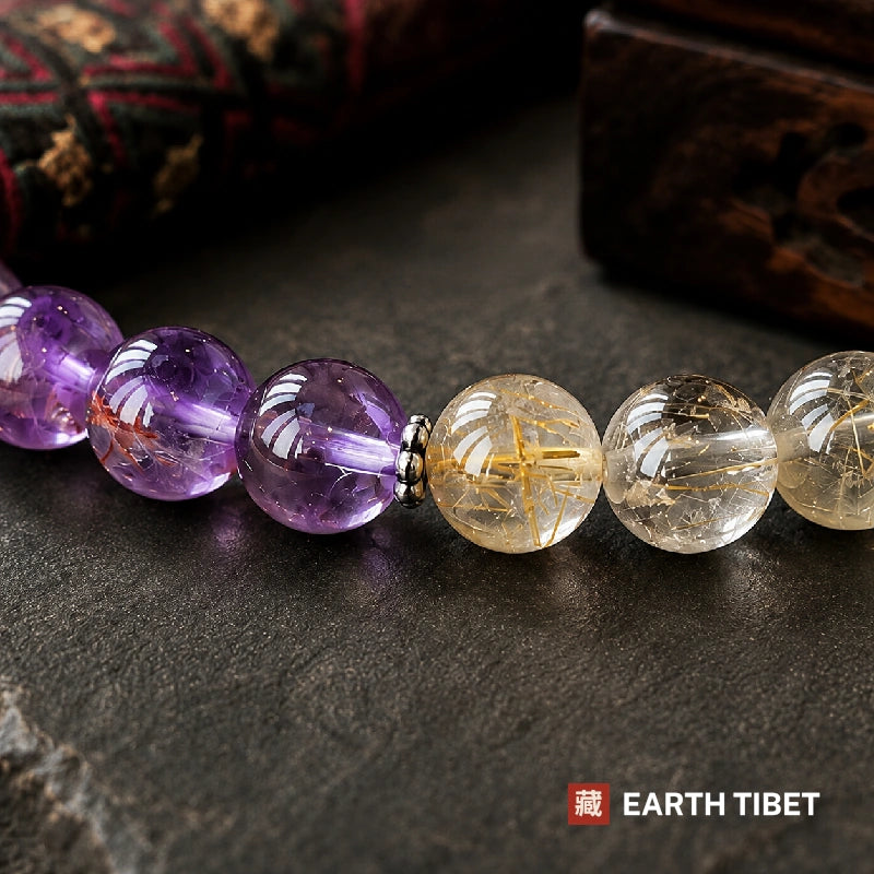 Macro of the amethyst and rutilated quartz junction, gold rutile needles inside the beads
