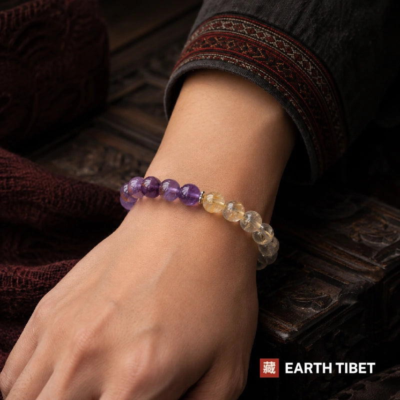 Amethyst rutilated quartz bracelet worn on a wrist, purple half forward