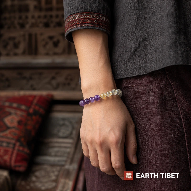 Amethyst rutilated quartz bracelet worn with grey linen and maroon trousers