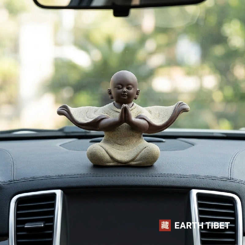 Baby monk flowing robe statue in matte ceramic, sleeve tips curling upward