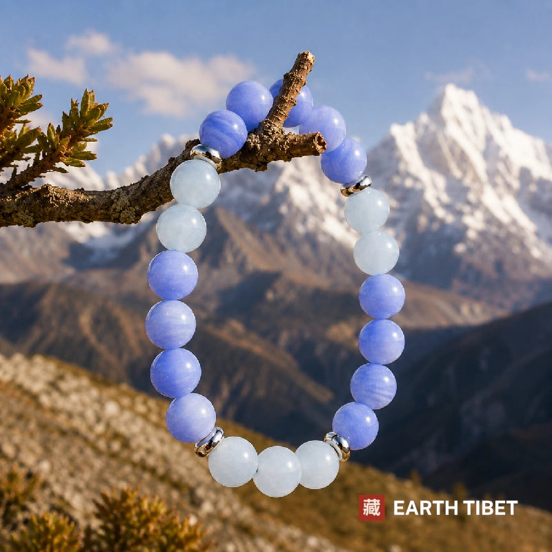 Blue lace agate and aquamarine stretch bracelet against carved wood