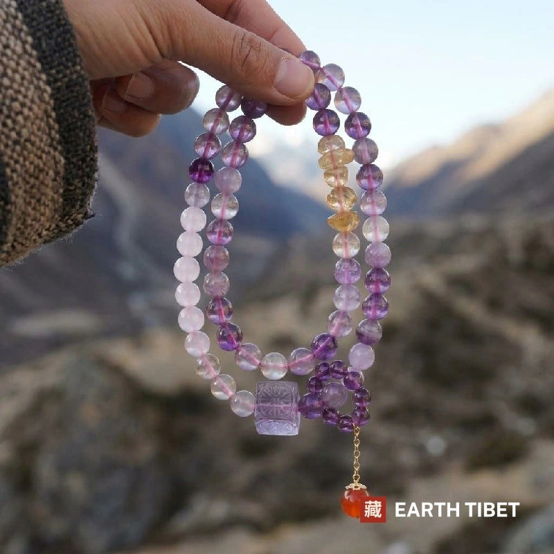Double wrap amethyst bracelet held up in front of Himalayan mountains