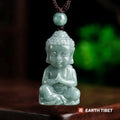Front view of the jadeite Buddha pendant showing the snail-shell curls, ushnisha and long earlobes