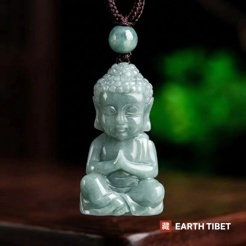 Front view of the jadeite Buddha pendant showing the snail-shell curls, ushnisha and long earlobes