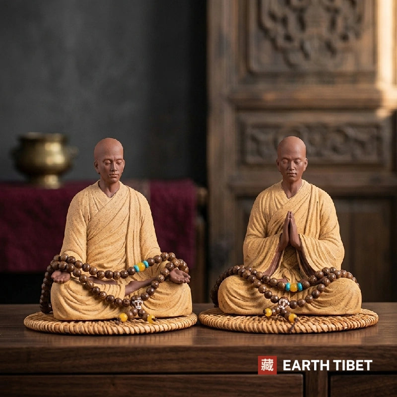 Ceramic meditating monk statue in a matte ochre robe with a bodhi seed mala