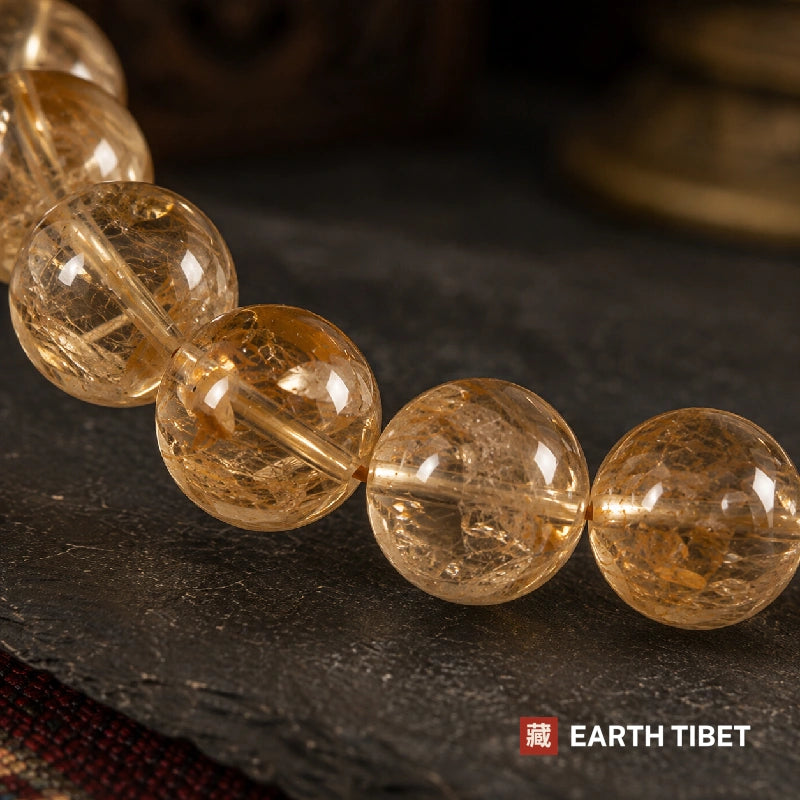 Macro of citrine beads showing the internal fracturing that catches light like frost