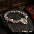 Clear quartz bracelet with a raw terminated crystal point and a brushed silver barrel bead