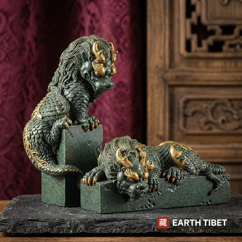 Green and gold panlong dragon statues, one upright on a block and one lying along a bar