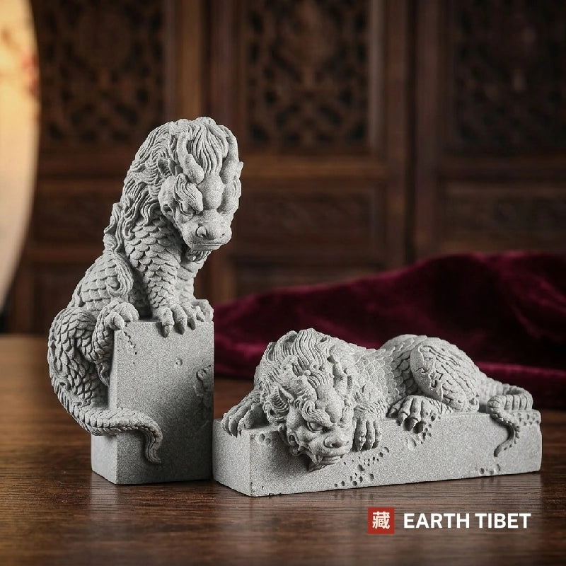 Grey sandstone coiled dragon statues, vertical and horizontal, against a carved screen