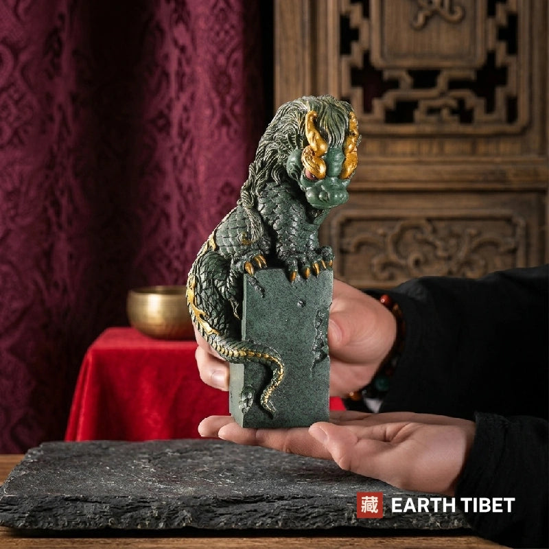 Coiled dragon guardian statue in sandstone with gilded horns and claws