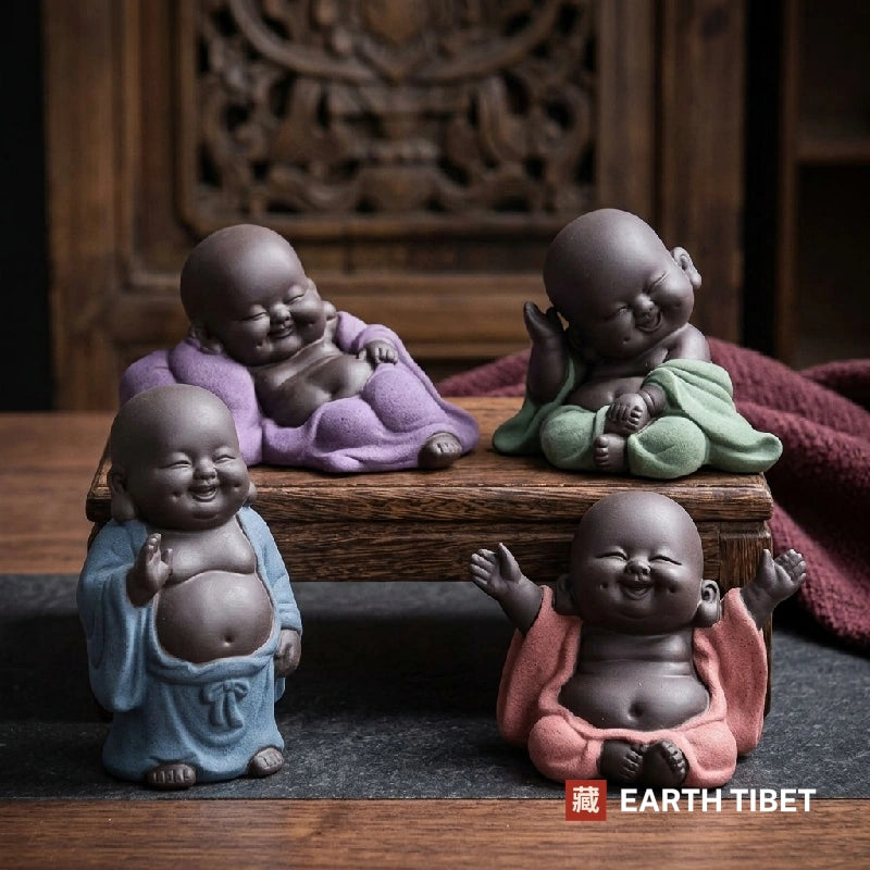 The four baby Budai poses grouped on a carved wooden table