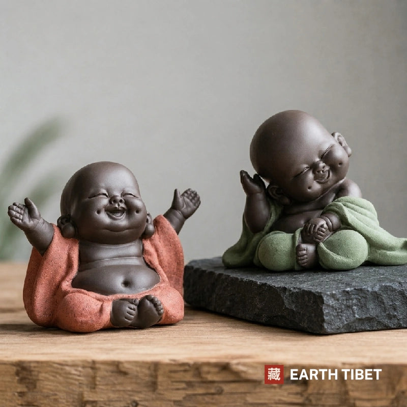 Coral sitting and green thinking baby Buddha tea pets side by side