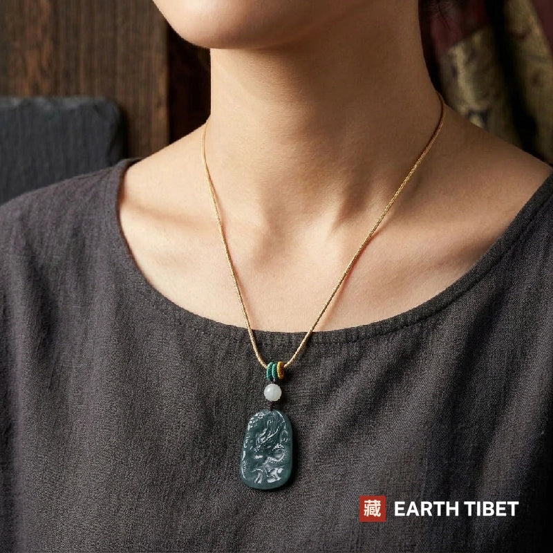 Dragon jade necklace worn at the chest over a grey linen top