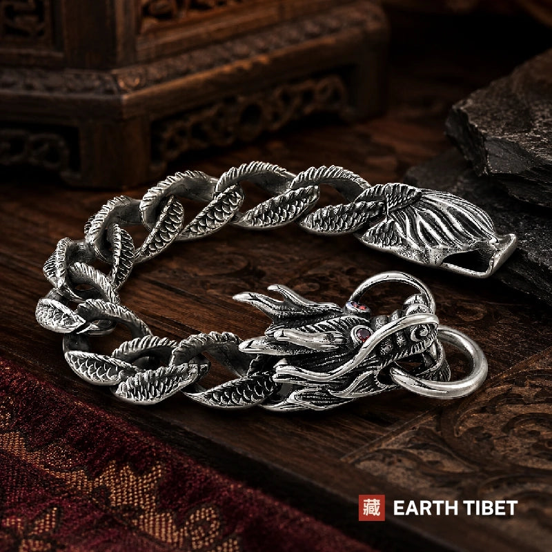 Dragon scale bracelet laid in a loop on slate showing the linked scale band