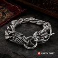 Dragon scale bracelet on dark slate beside a red carpet and carved panel