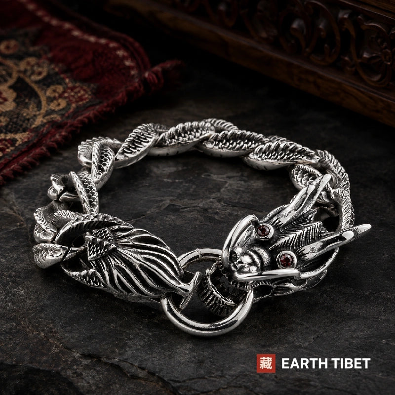 Dragon scale bracelet on dark slate beside a red carpet and carved panel