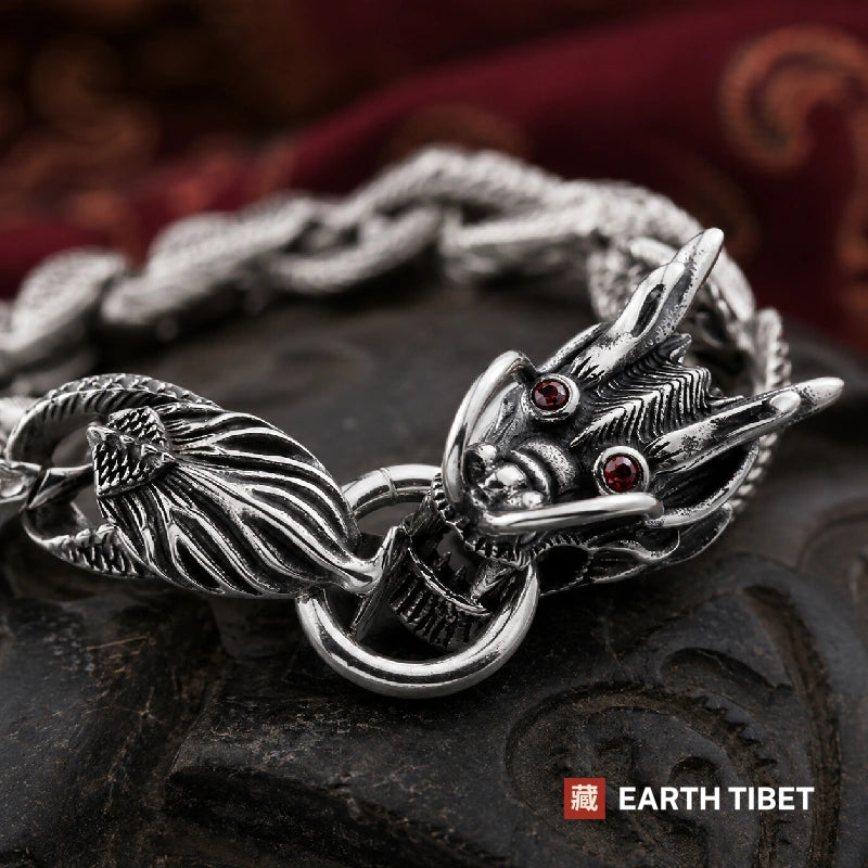 Macro of the dragon head clasp on the dragon scale bracelet, red stones set as eyes