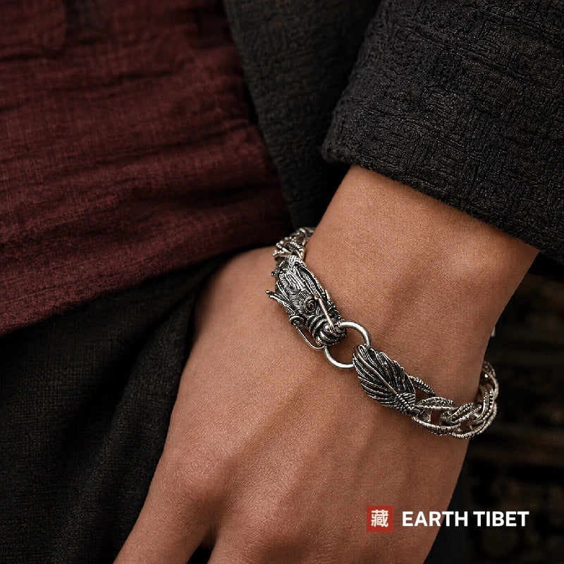 Dragon scale bracelet worn on a wrist below a dark jacket cuff