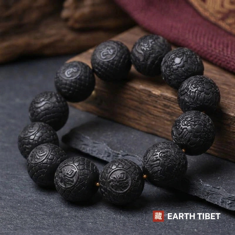 Ebony dragon bracelet of twelve 20mm carved beads on elastic