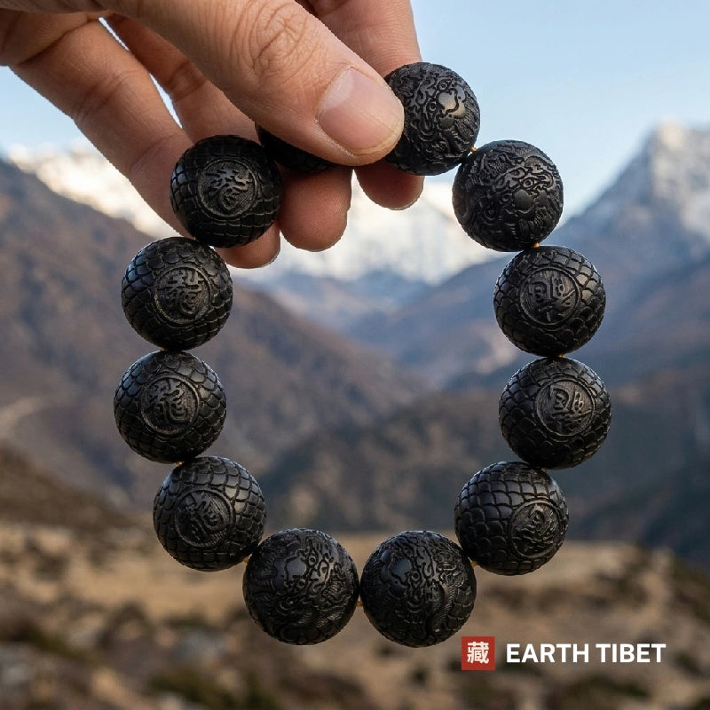 Twelve carved ebony beads, each with the character for dragon in a roundel
