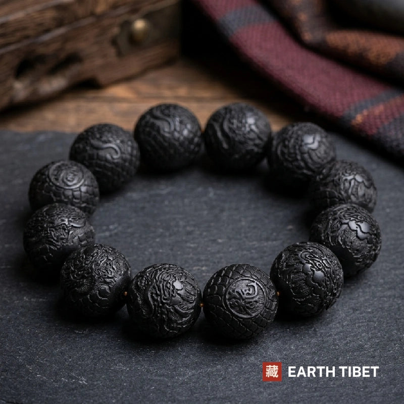 Ebony dragon protection bracelet resting on dark slate