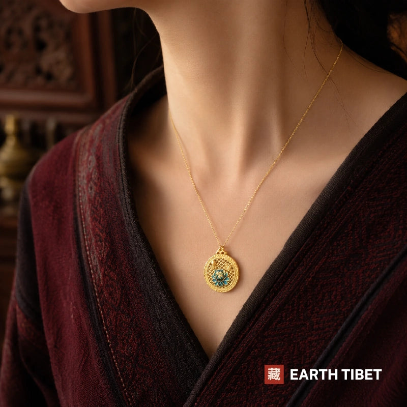 Blue lotus openwork necklace worn at the sternum over a maroon wrap top
