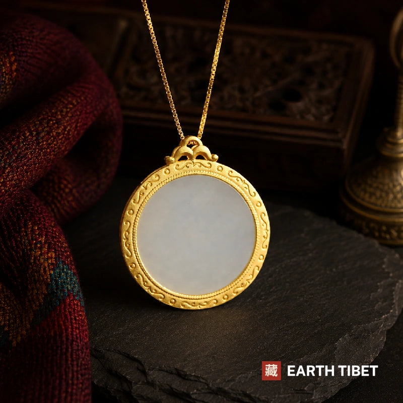 Reverse of the lotus pendant, a plain white chalcedony disc in a scrolled gold bezel