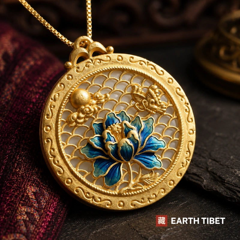 Macro of the blue lotus pendant showing the bird, the gold orb and the cloud scroll border