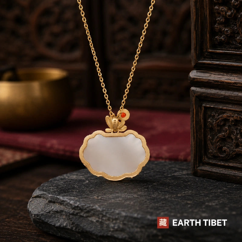 Back of the white agate ruyi lock pendant, plain polished stone in a gold plated S925 silver bezel