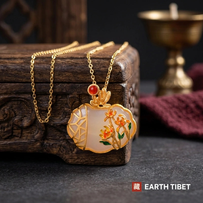 Enamel chrysanthemum necklace against a carved wooden box, chain looped beside it