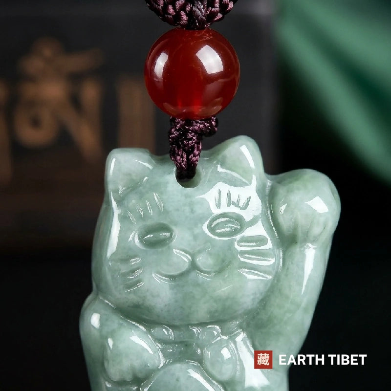 Close view of the carved face, whiskers and raised left paw on the jadeite fortune cat