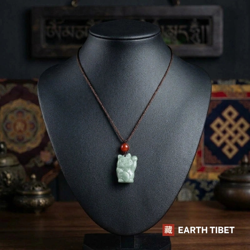 Jadeite fortune cat necklace on a display bust showing where the pendant sits on the chest