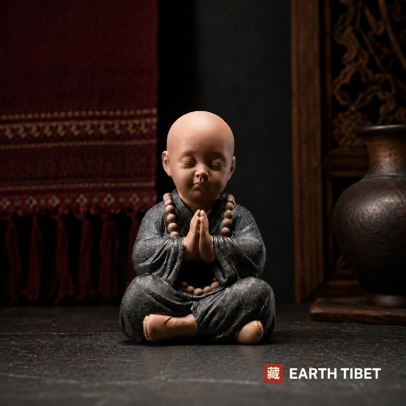 Ceramic monk figure with palms pressed together, the fourth monk, do no evil