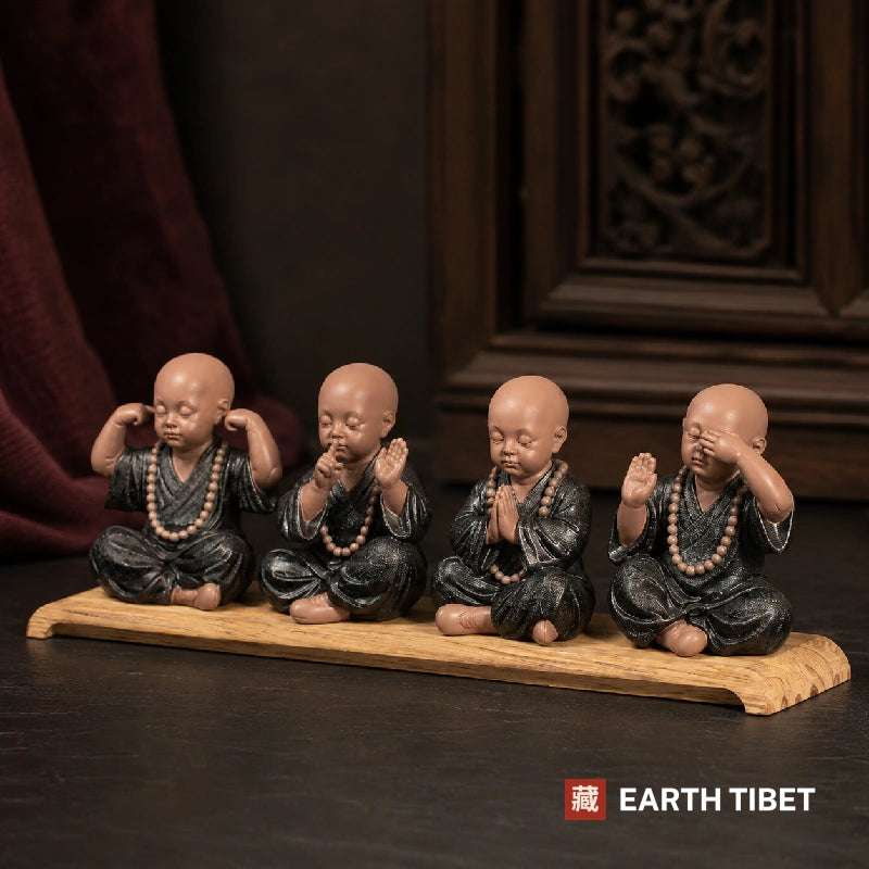 The four monks ceramic set lined up on a wooden stand in front of a carved Chinese screen