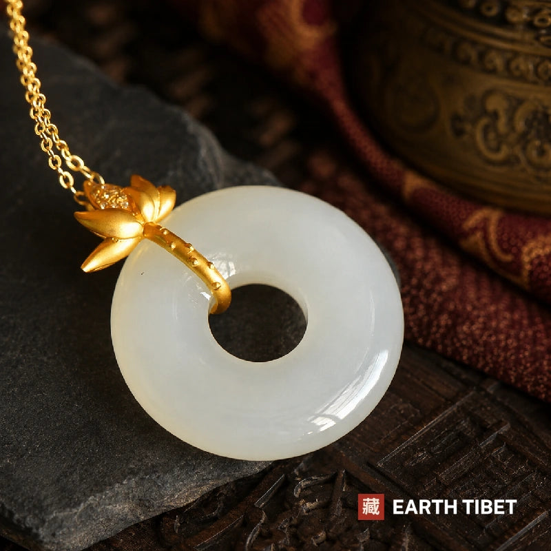 Close up of the gold lotus stem arcing over the rim and hooking into the hole of the agate disc