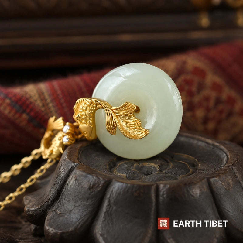 Side view of the koi jade pendant on a carved wooden lotus stand, showing the disc thickness