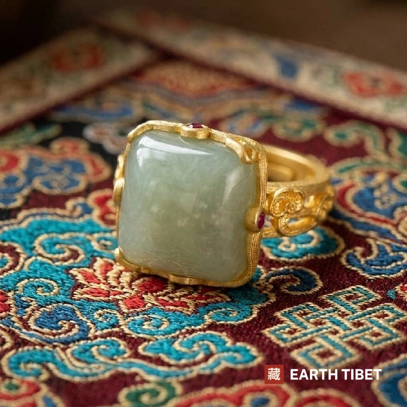 Close view of the celadon green cabochon and the small red stones at the corners