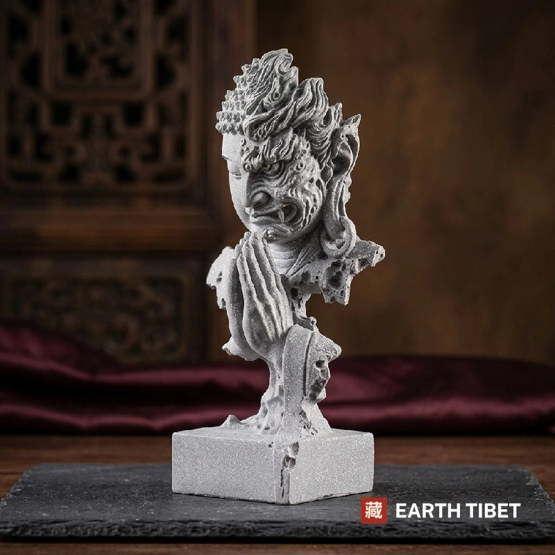 Half Buddha half demon statue carved in grey sandstone on a square plinth