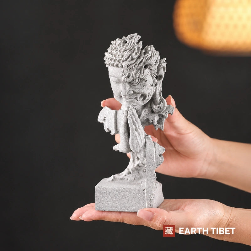 The half Buddha half demon statue held in two hands for scale