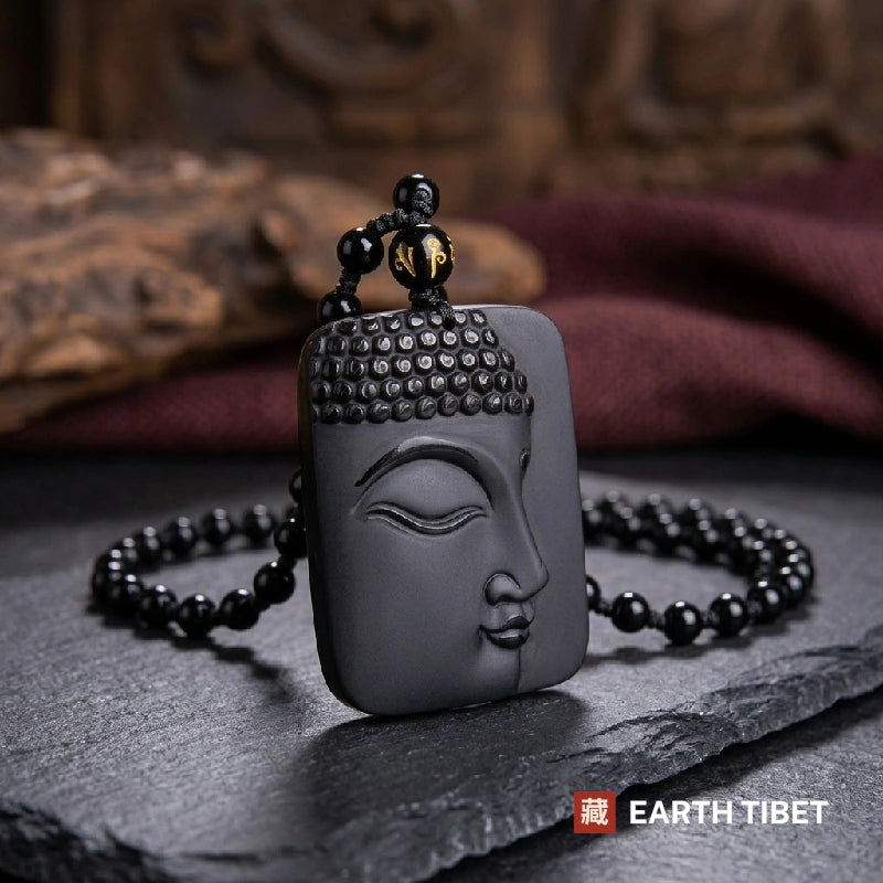 Obsidian Buddha necklace with round black beads and a gold Sanskrit bead