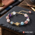 Pastel crystal bracelet with gold wire wrapped beads on slate