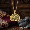 Jade cloud elephant necklace hanging in front of a carved wooden panel