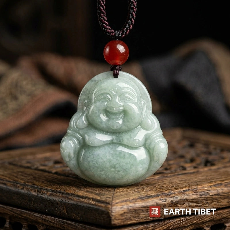 Laughing Buddha jadeite pendant resting on a carved wooden box