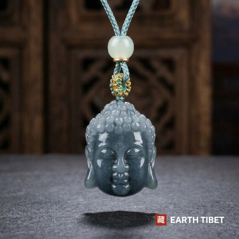 Buddha head pendant hanging, showing the dark face and paler grey-green curls