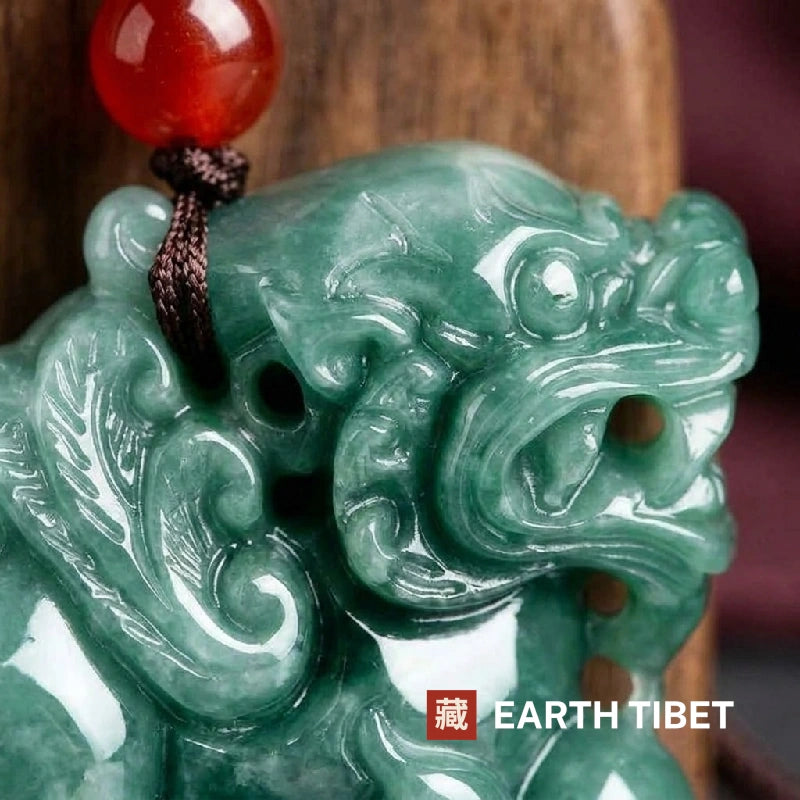 Close view of the pixiu's open jaws, eye and feathered wing carved in green jadeite