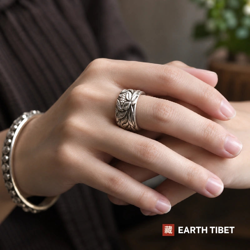 Woman wearing the wide Lotus Heart Sutra ring on her middle finger