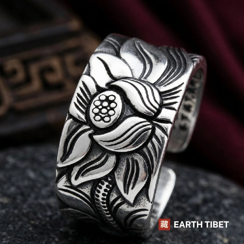 Close view of the carved lotus with its open seed pod and beaded stem on the ring band
