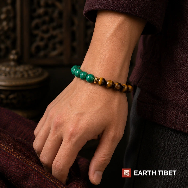 Malachite tiger eye bracelet on a wrist showing the banded green beads
