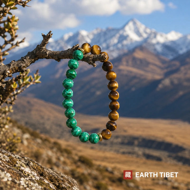 Malachite tiger eye bracelet hanging on a branch against Himalayan mountains