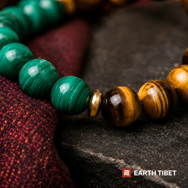 Macro of the malachite and tiger eye junction, banding and chatoyancy either side of a gold rondelle